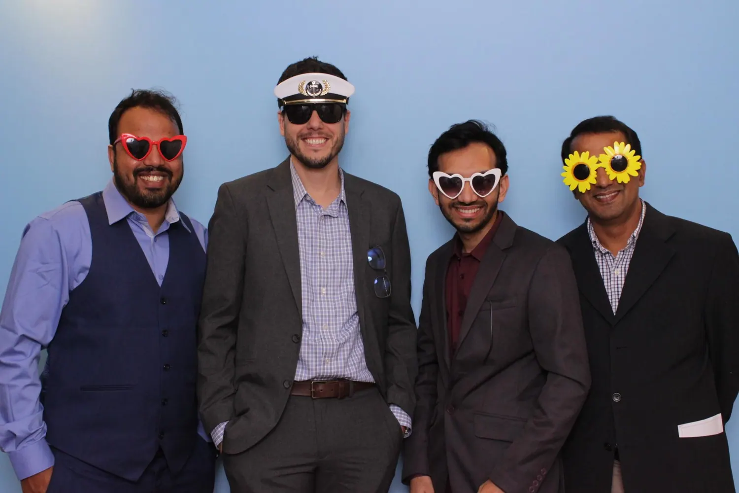 Md Akkas Ali with three colleagues wearing novelty glasses at a department event photo booth